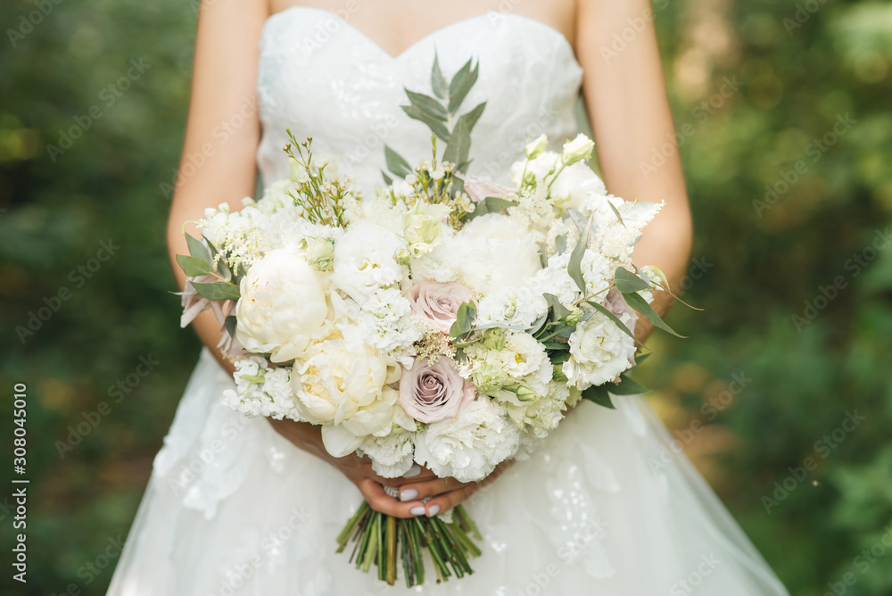 Bridal morning details. Wedding beautiful bouquet in the hands of the bride, selectoin focus