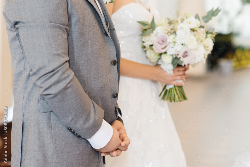 Bridal morning details. Wedding beautiful bouquet in the hands of the bride, selectoin focus Bridal morning details. Wedding beautiful bouquet in the hands of the bride, selectoin focus