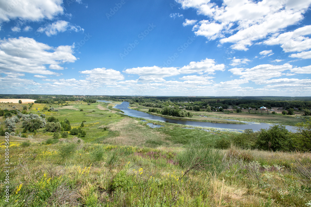 View on a Ross river in a bright summer day. Green grass, cloudy sky. Ukraine View on a Ross river in a bright summer day. Green grass, cloudy sky. Ukraine