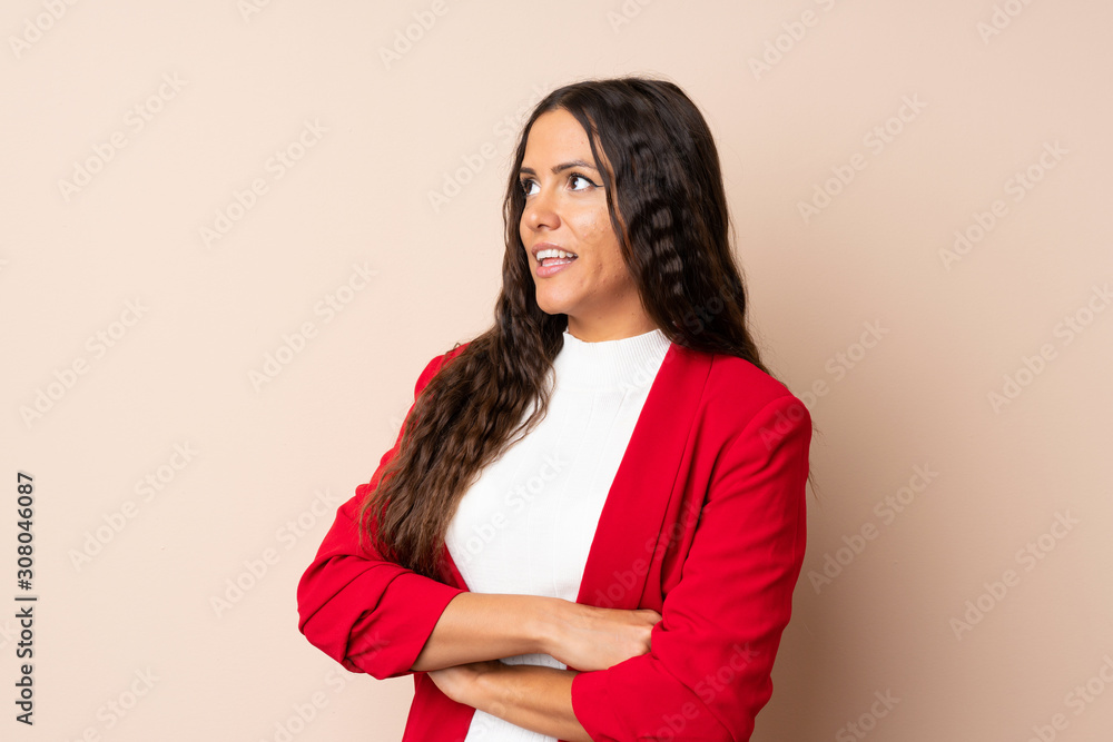 Fototapeta premium Young woman over isolated background laughing
