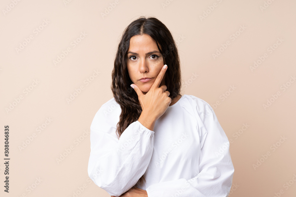 Young woman over isolated background thinking an idea Young woman over isolated background thinking an idea