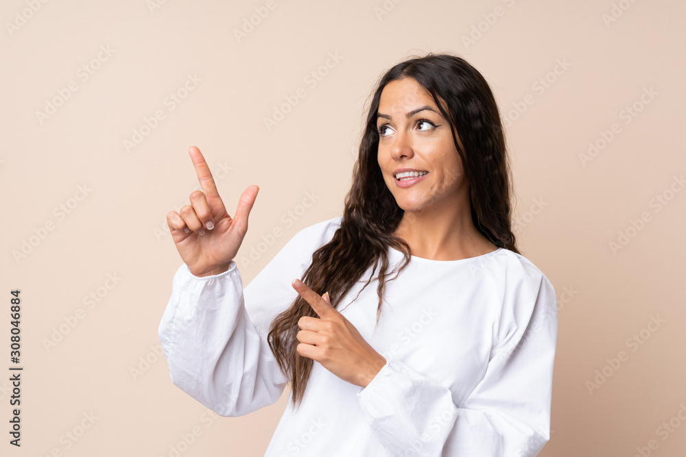 Young woman over isolated background pointing with the index finger a great idea Young woman over isolated background pointing with the index finger a great idea