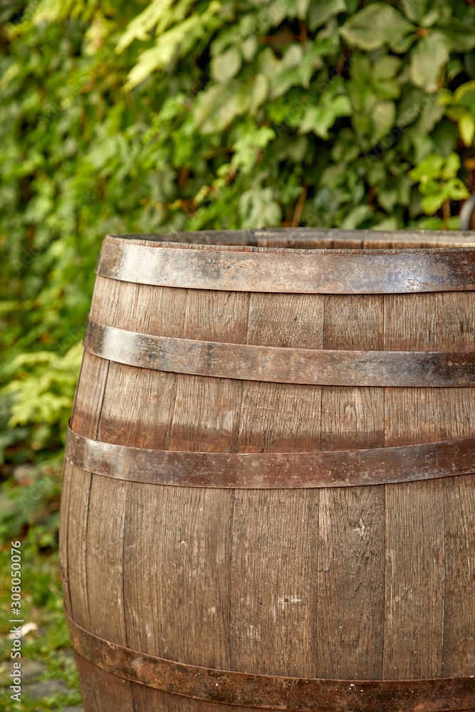 old wine barrel on the paving stones old wine barrel on the paving stones