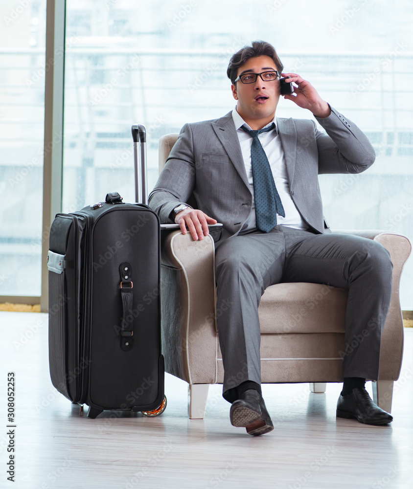 Fototapeta premium Young businessman in airport business lounge waiting for flight