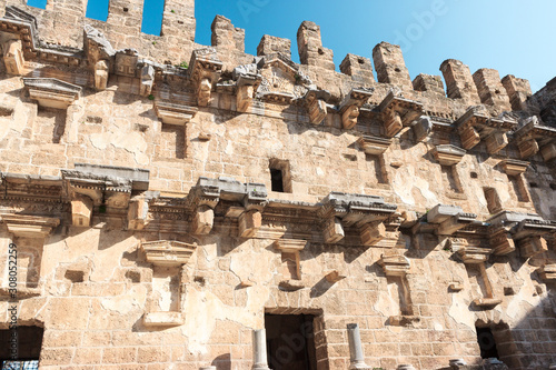 Aspendos ancient amphitheater walls with blue sky in Antalya, Turkey. Amphitheater ruins from roman empire.
