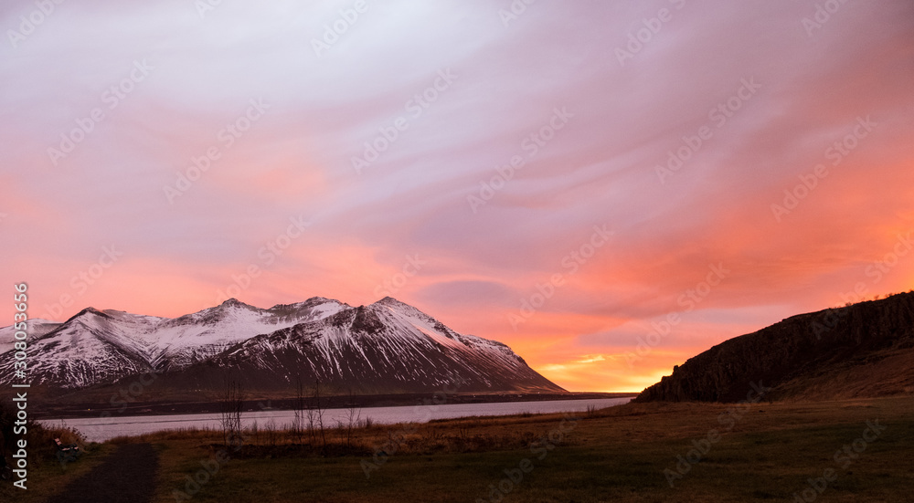 Dramatic sunset over the mountains and the sea in Iceland