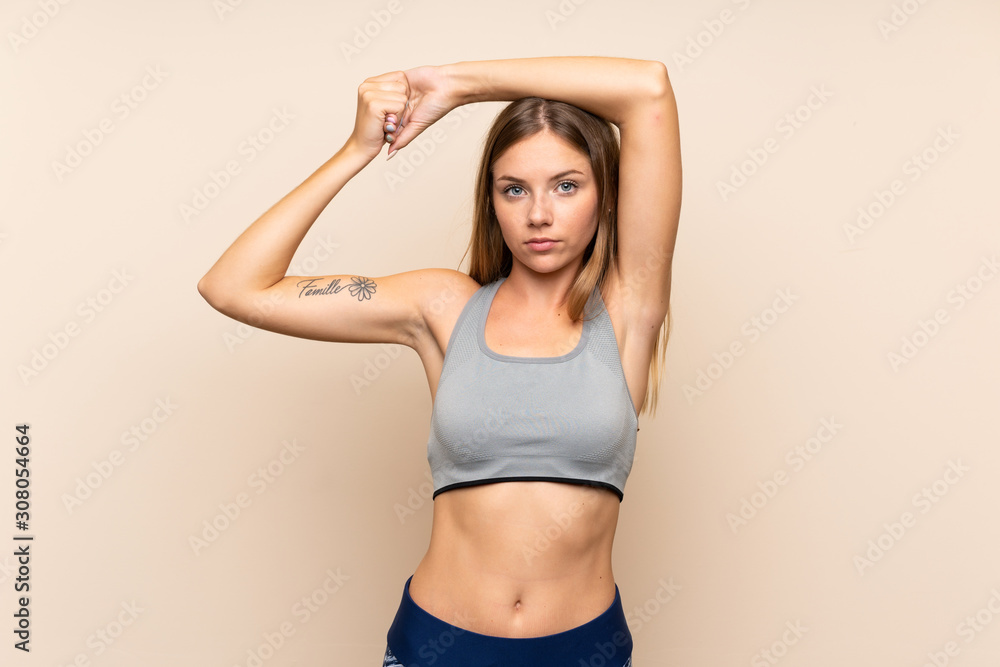 Obraz premium Young blonde sport girl over isolated background stretching