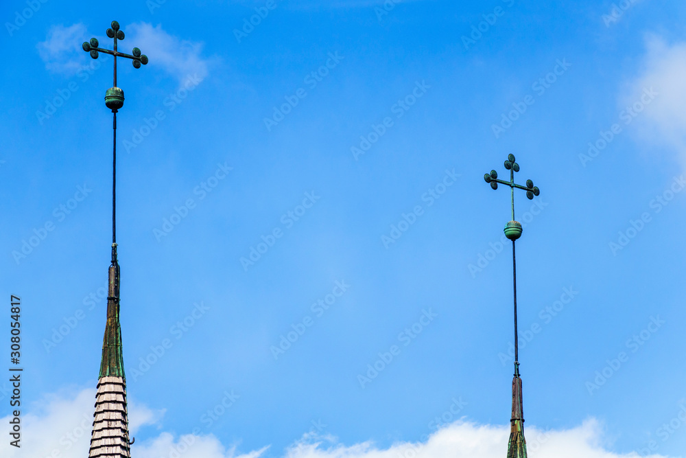 Church spire with tree clover at a blue sky