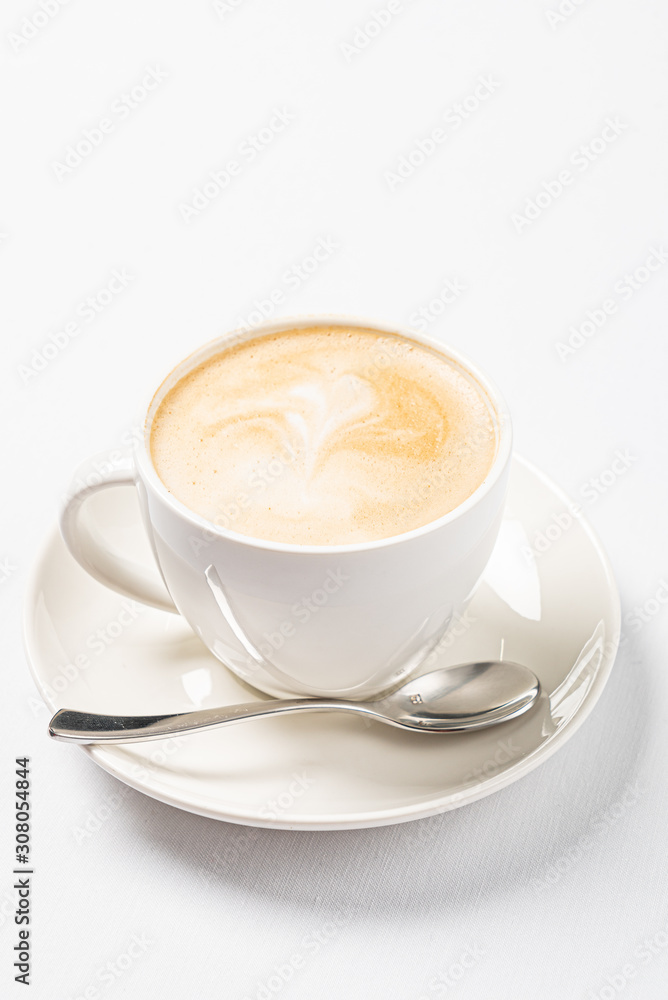 cup of cappuccino on the white cup of cappuccino on the white