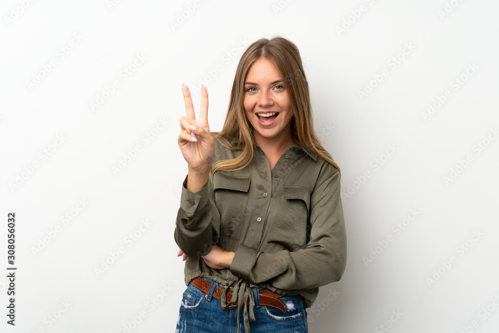 Lithuanian blonde girl over isolated white background smiling and showing victory sign Lithuanian blonde girl over isolated white background smiling and showing victory sign