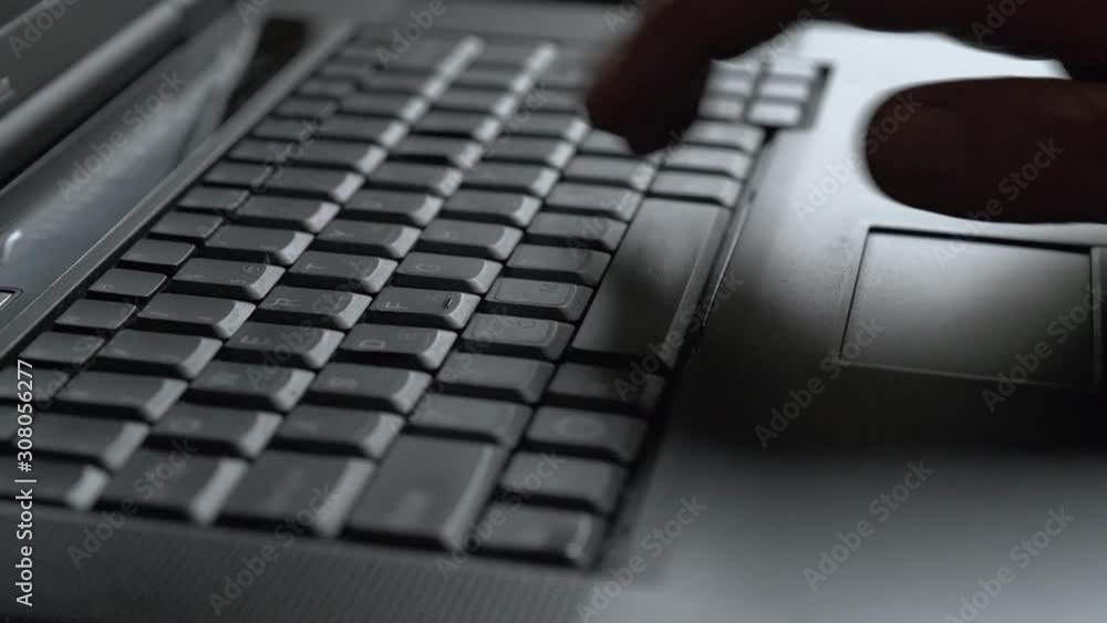 Closeup of a man working and typing text on a laptop computer keyboard. Closeup of a man working and typing text on a laptop computer keyboard.