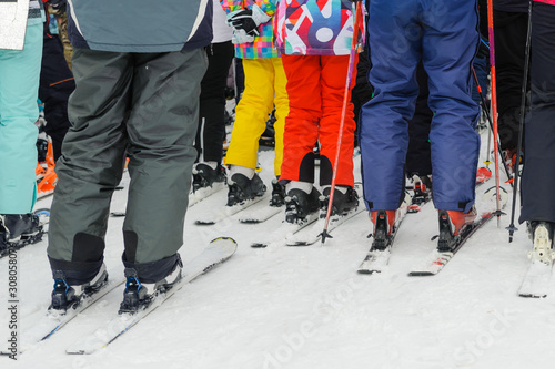 Skiers, adults and children, stand in line for the lift: the concept is a popular sport, crowded on weekends.