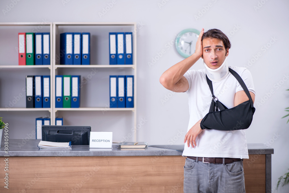 Young man at hospital reception desk Young man at hospital reception desk