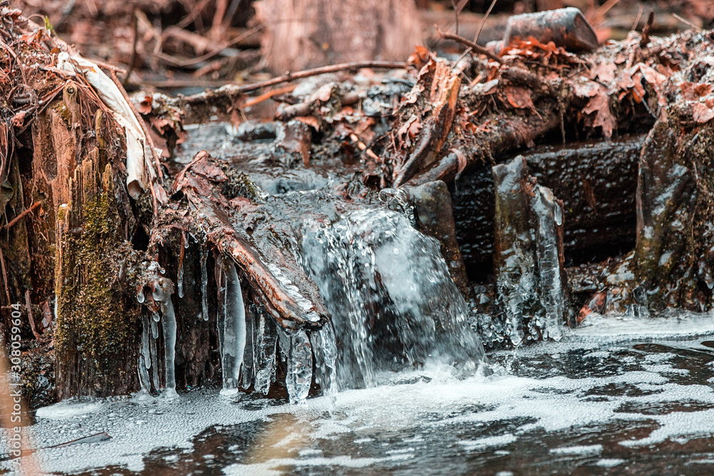 A small freezing waterfall in a winter Park. A small freezing waterfall in a winter Park.