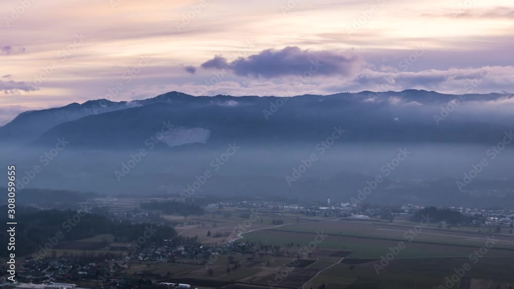 Time lapse clouds moving over valley with mountains in background Time lapse clouds moving over valley with mountains in background