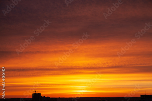 Silhouette of construction crane on sunset background © oleg_ru