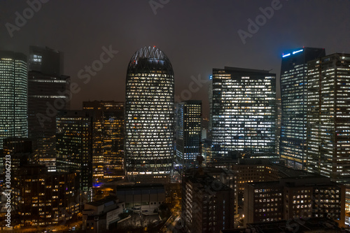 Aerial drone night shot of Skyscrapers with lights on in La Defense, financial district of Paris