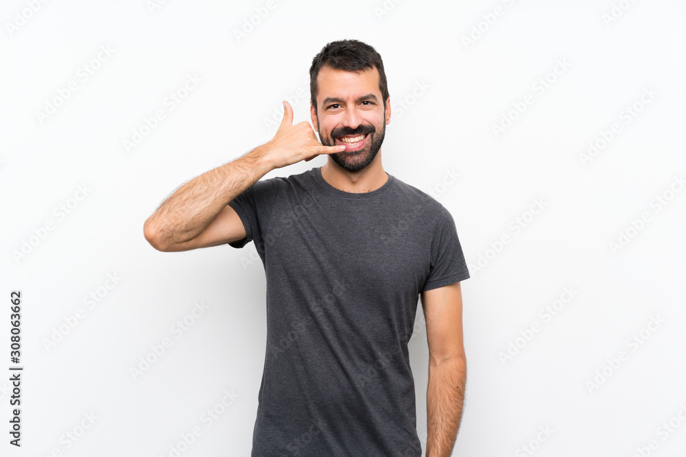 Young handsome man over isolated white background making phone gesture. Call me back sign Young handsome man over isolated white background making phone gesture. Call me back sign