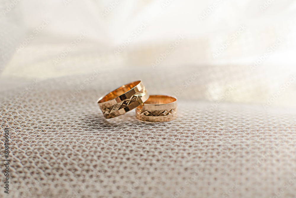 gold wedding rings for newlyweds on a white background gold wedding rings for newlyweds on a white background
