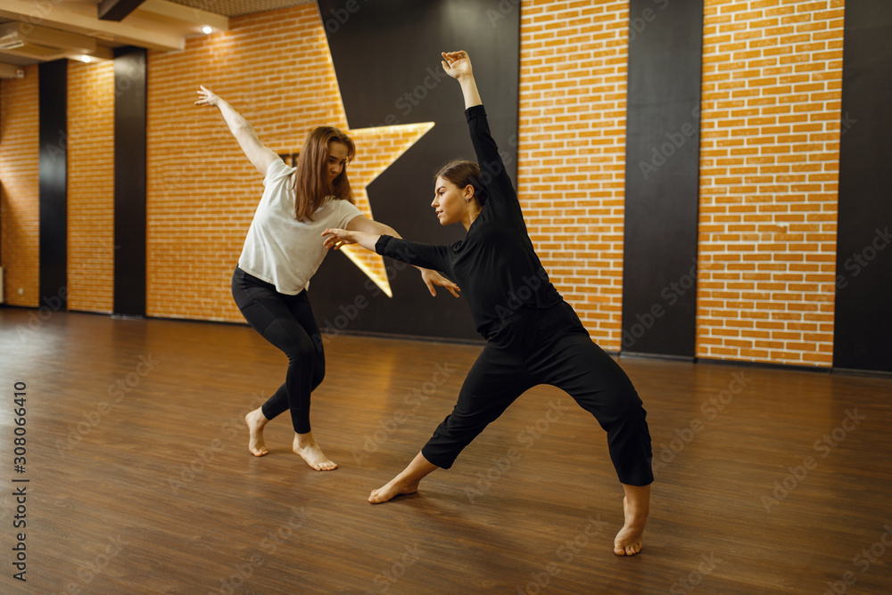 Two contemporary dance performers poses in studio - obrazy, fototapety, plakaty 