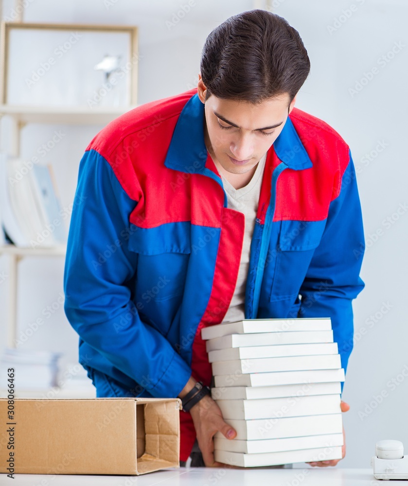 Worker in publishing house preparing book order Worker in publishing house preparing book order