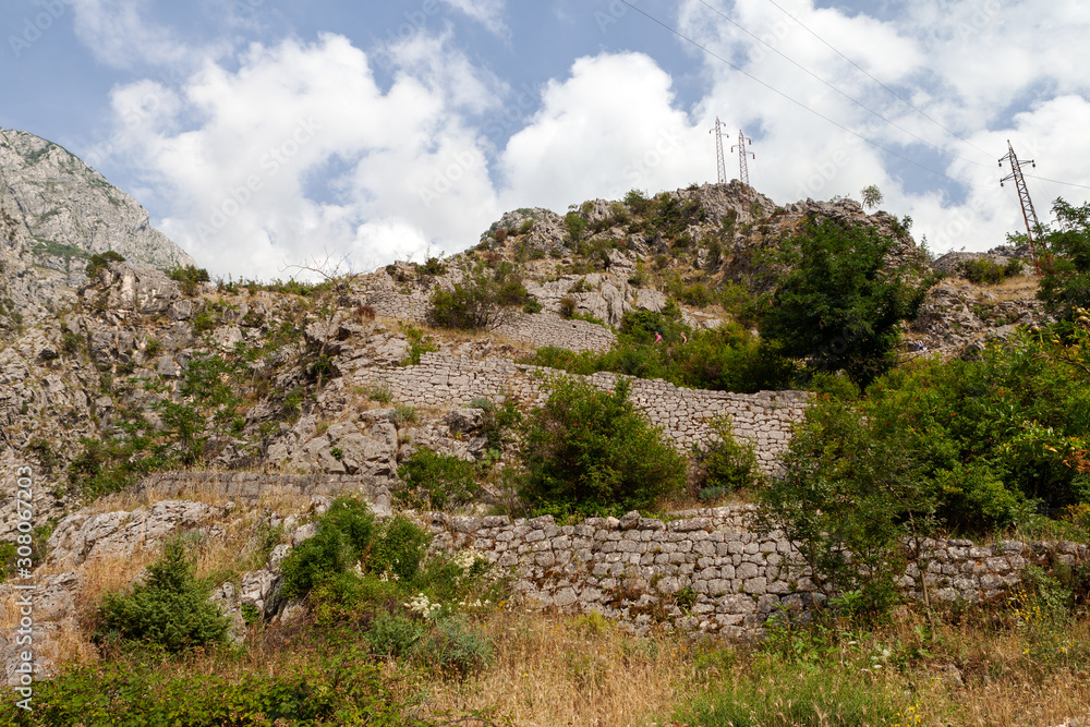 the trail is fenced with stones in the fortress of Kotor, Montenegro the trail is fenced with stones in the fortress of Kotor, Montenegro