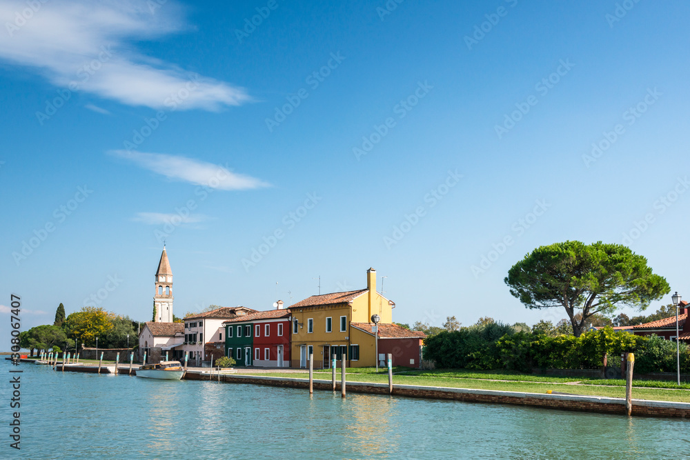 Colourful houses and bell tower on Mazzorbo island pier, near Burano, Venice, Italy