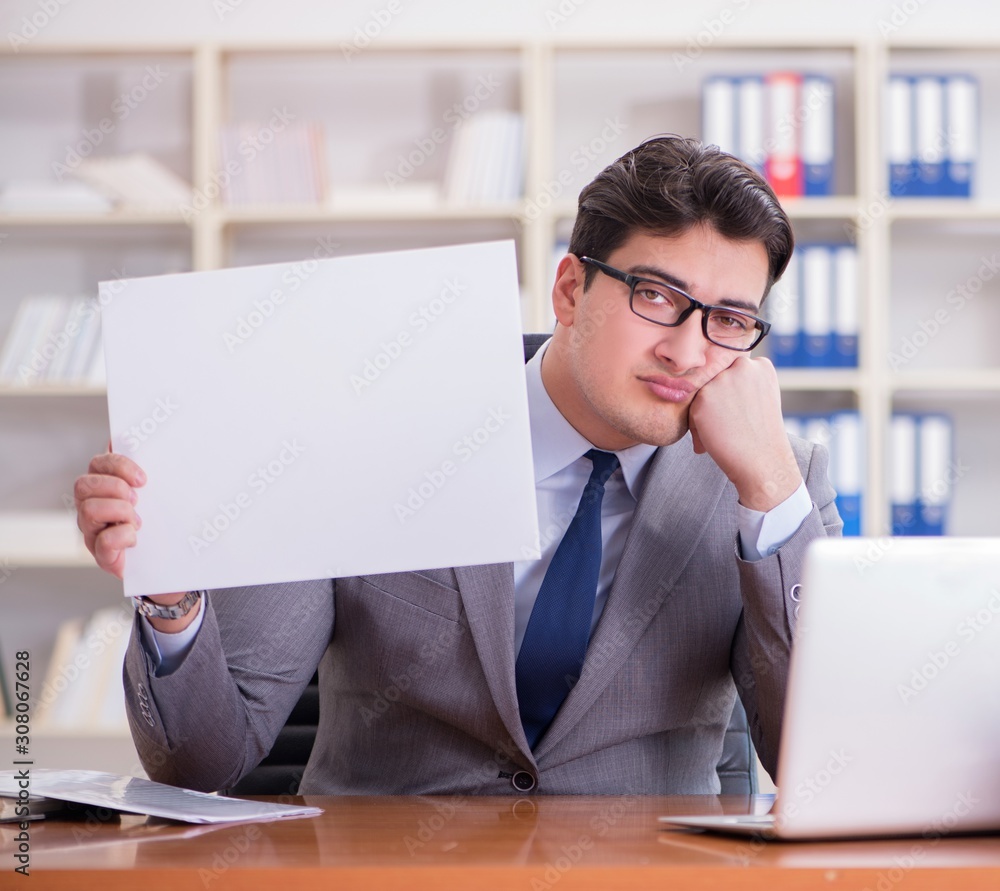 Businessman in office holding a blank message board Businessman in office holding a blank message board