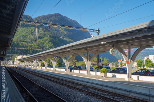 Empty platform in train station on clear blue sky and mountain background with copy space