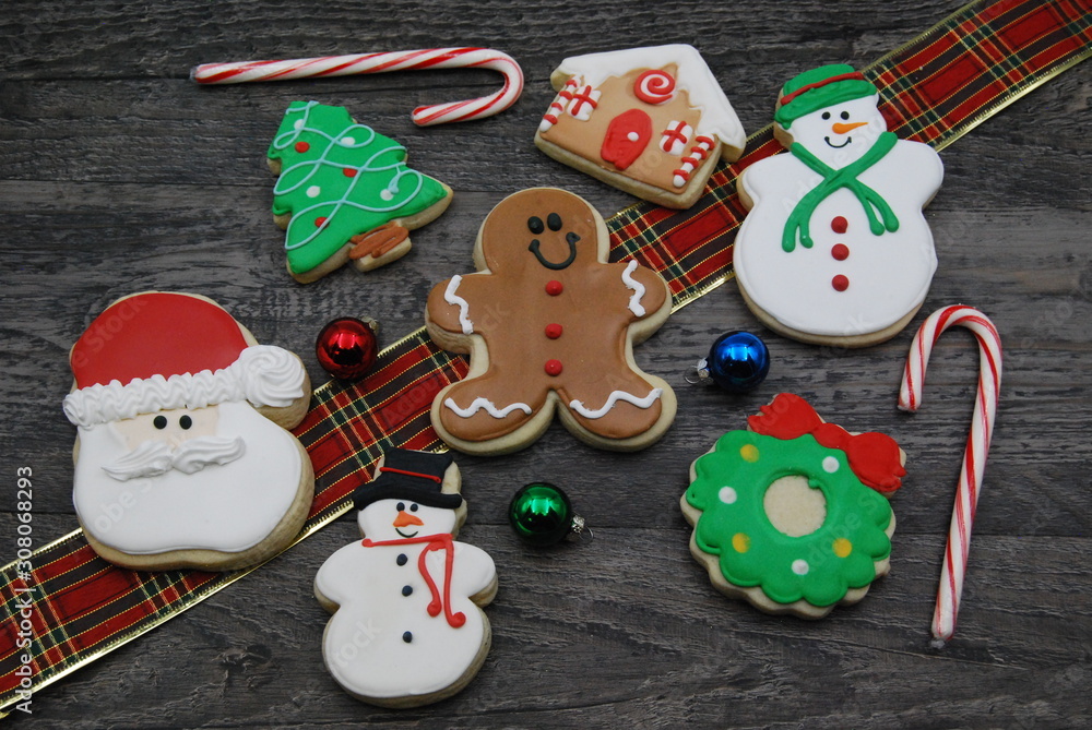 Top view of decorated Christmas Cookies on rustic wood with Holiday Decorations