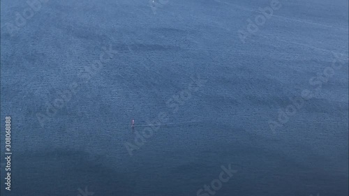 Close up time lapse blue sea with windsurfers surfing on waves
