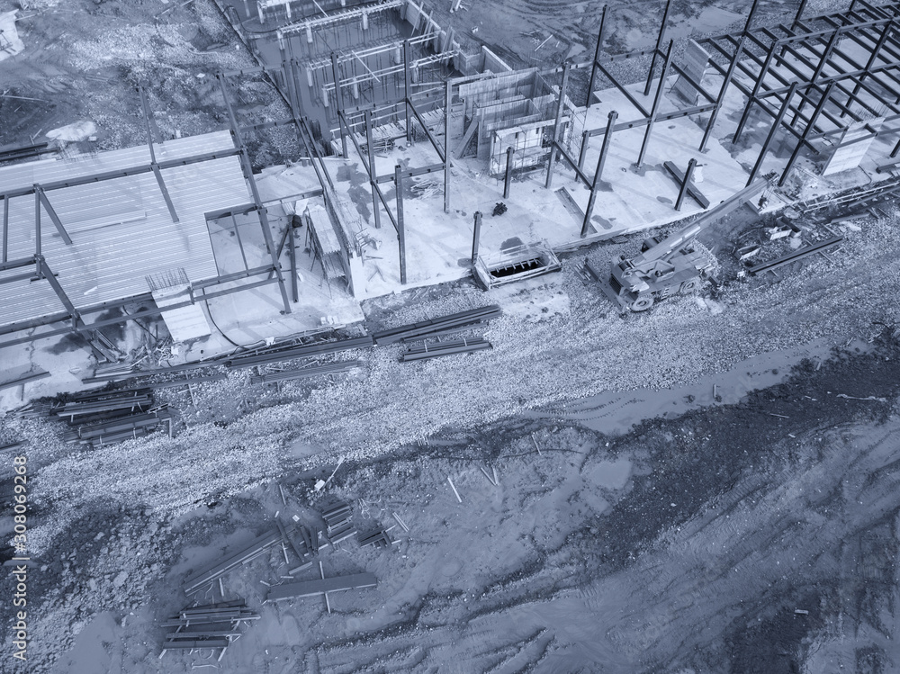 Aerial view of a construction site with heavy machinery for material lifting