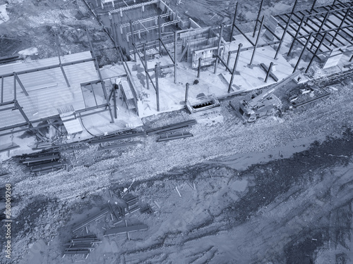 Aerial view of a construction site with heavy machinery for material lifting