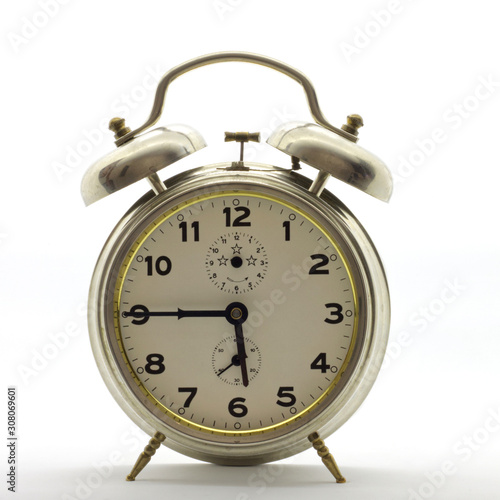 Old-style alarm clock, metal, it's quarter to six.