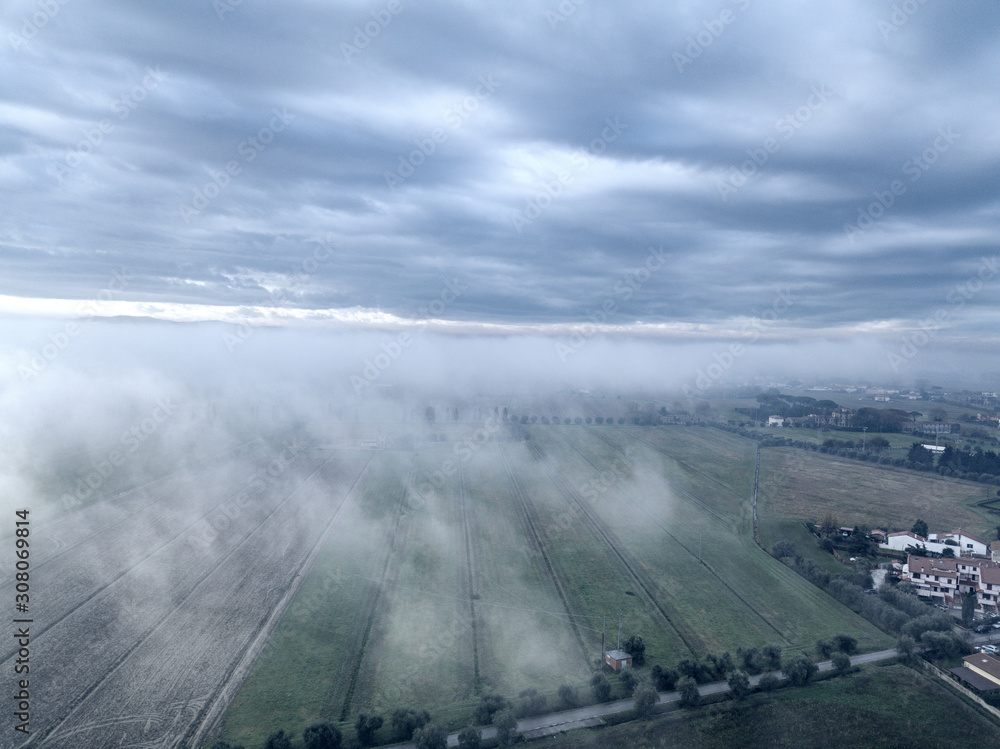 Clouds and fog over the town, Tuscany