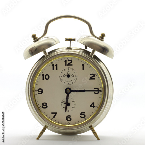Old-style alarm clock, metal, it's quarter past six.