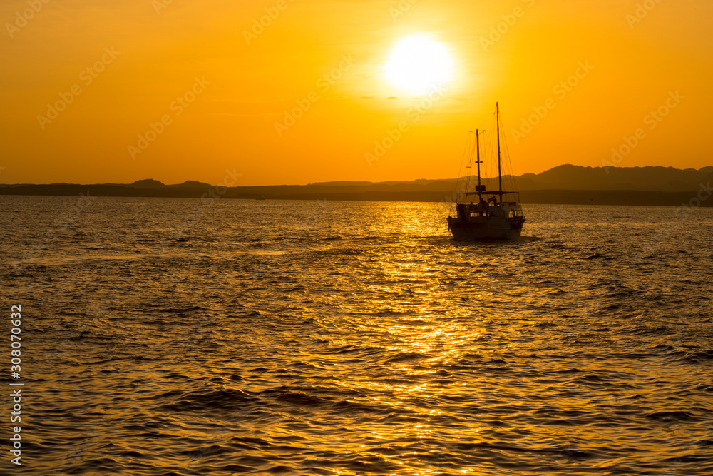 Sunset at sea. toned. Yacht in the sunset. copy space Sunset at sea. toned. Yacht in the sunset. copy space