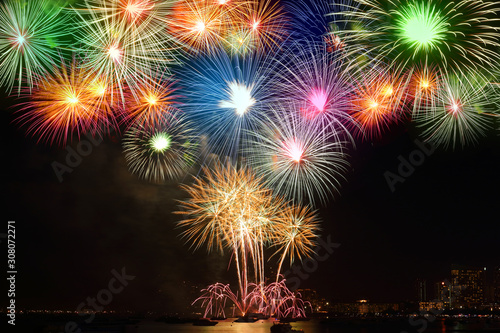 Beautiful color fireworks Show in the dark sky in the sea, close to the beach at the city of tourism. Happy New Year 2020