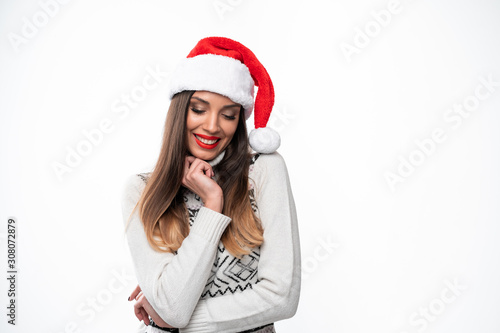 Close up portrait beautifiul caucasian woman in red Santa hat on white studio background. Christmas and New Year holiday concept.