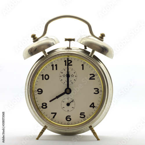 Old-style alarm clock, metal, it's eight o'clock.