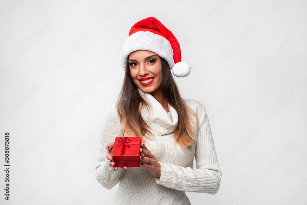 Close up portrait beautifiul caucasian woman in red Santa hat on white studio background. Christmas and New Year holiday concept. Close up portrait beautifiul caucasian woman in red Santa hat on white studio background. Christmas and New Year holiday concept.