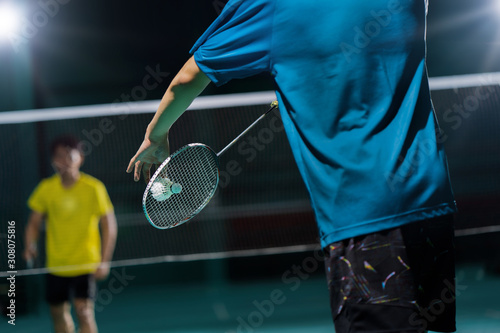 Asian badminton player is hitting in court © torwaiphoto
