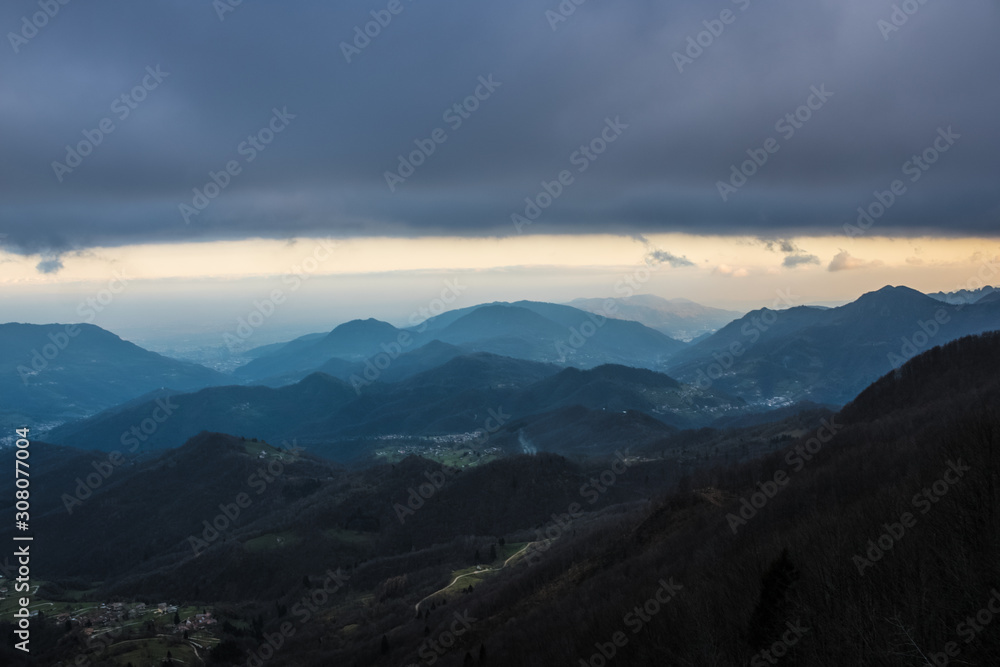 Beautiful mountain view on the cloudy day, the valley with the forest and mountains on the background, mountain landscape in Italy - Image