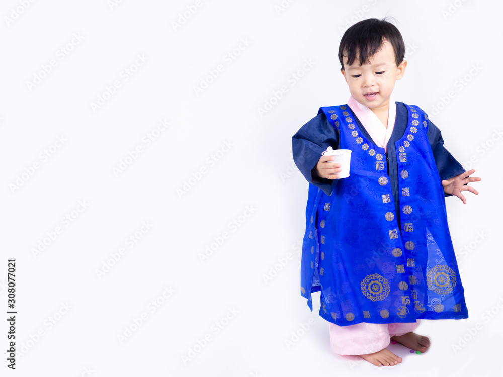 Asian little boy wearing a Korean Traditional Hanbok dress in white background Asian little boy wearing a Korean Traditional Hanbok dress in white background