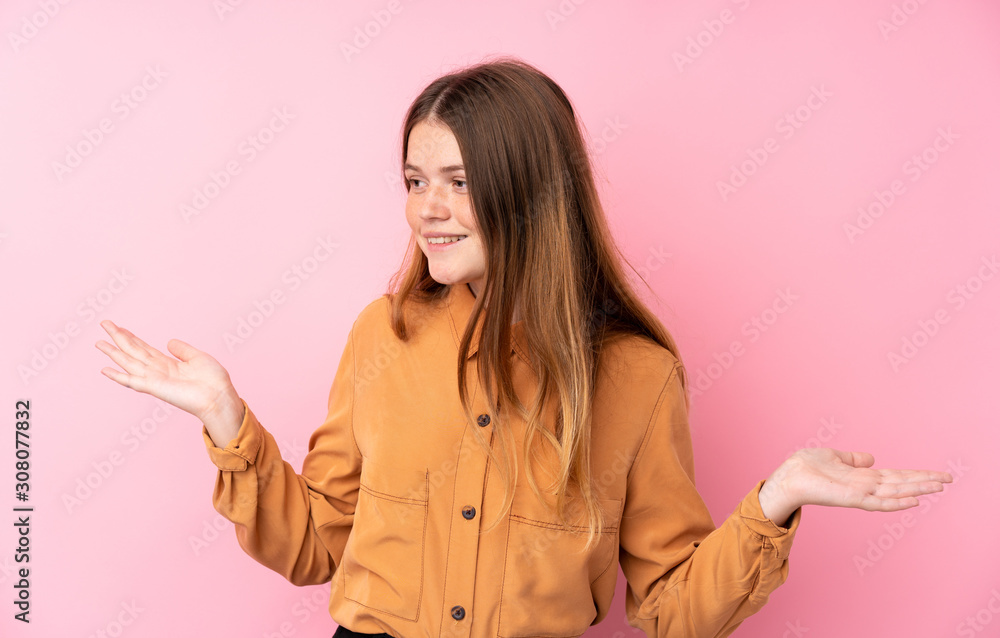 Ukrainian teenager girl over isolated pink background holding copyspace with two hands Ukrainian teenager girl over isolated pink background holding copyspace with two hands