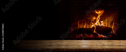 Empty table with burning fire photo