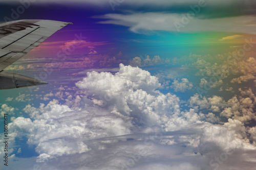 Fotografie Airplane wing, clouds and sky during the flight