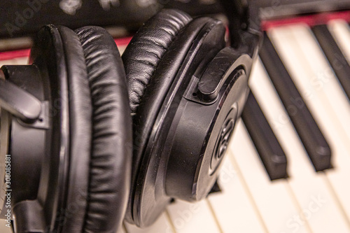 Piano keyboard with headphones for music Headphones on piano keyboard, close up © M.V.schiuma