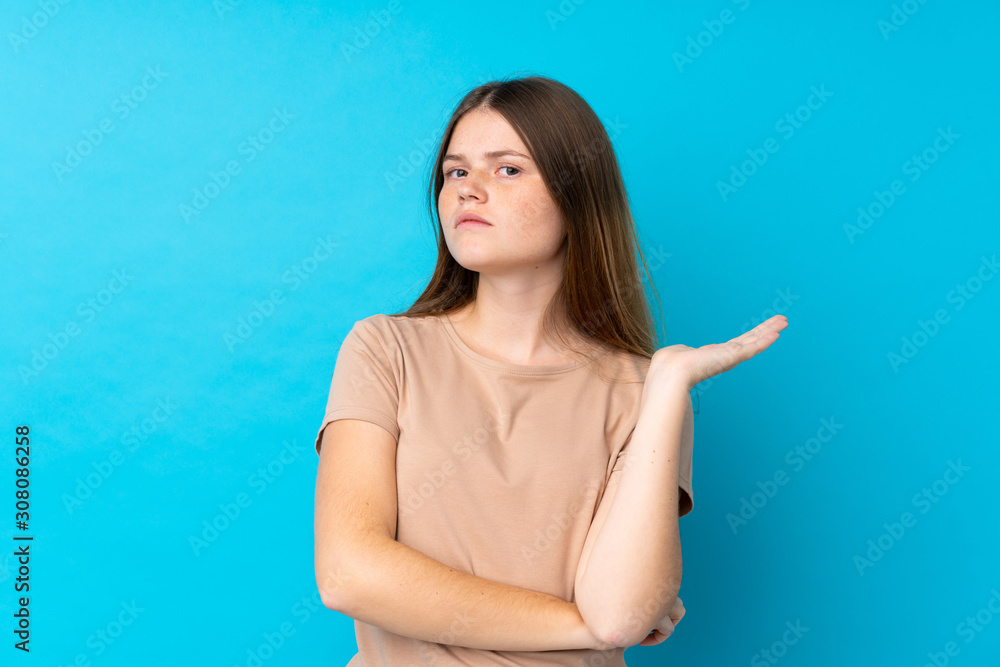 Ukrainian teenager girl over isolated blue background unhappy for not understand something Ukrainian teenager girl over isolated blue background unhappy for not understand something