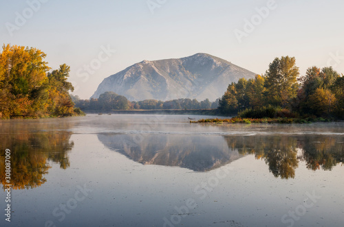 The remain of the reef of the ancient sea, composed of limestone - shikhan Yuraktau. Indian summer on the Belaya river.